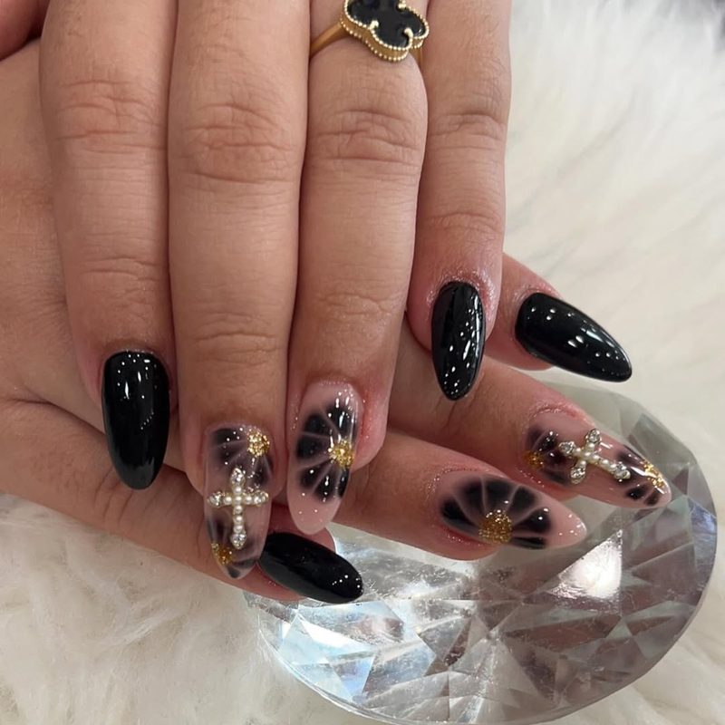 Black almond nails with crystal cross design